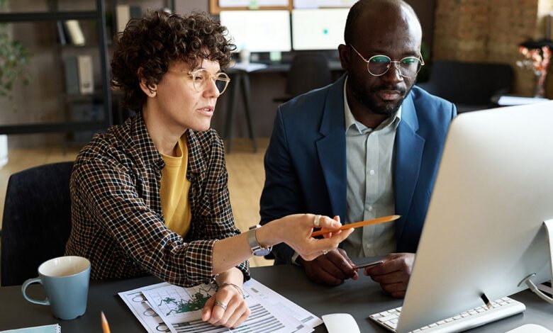 Office Workers Reviewing Submitted Job Applications For Employment Opportunity 780x470