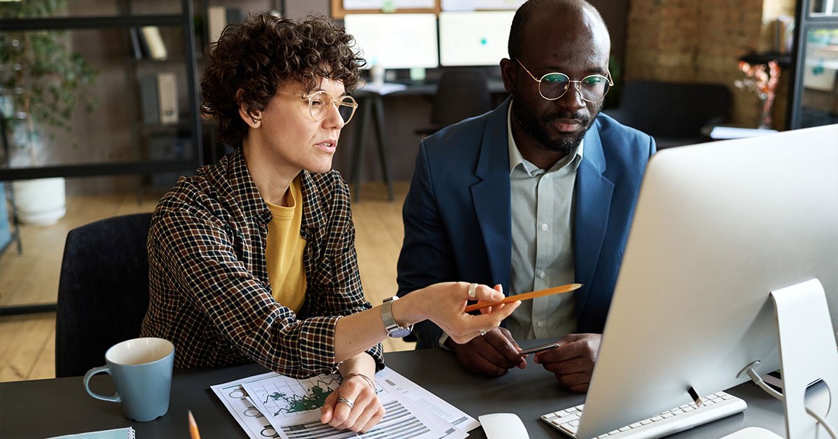 Canada Updates Reciprocal Employment Rules for Foreign Workers (2026 Guide) Office Workers Reviewing Submitted Job Applications For Employment Opportunity